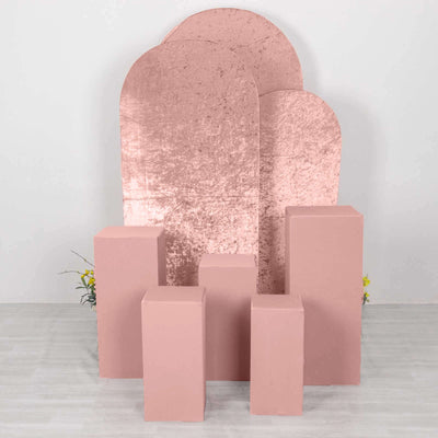Pink geometric display props on a plain backdrop for photography.