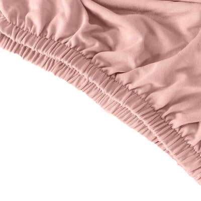 Soft pink fabric with elastic waistband detail, perfect for comfortable wear.