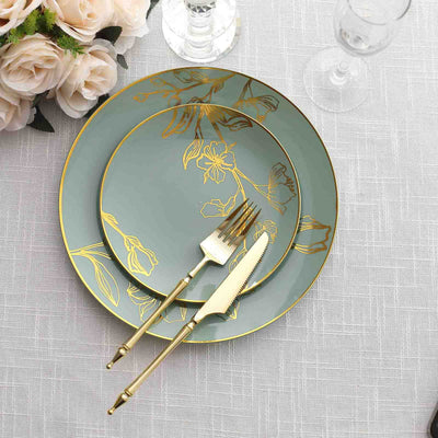 Elegant teal plates with gold floral design and gold utensils on a textured table linen.