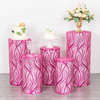 Colorful pink swirl display pedestals for cakes and floral arrangements.