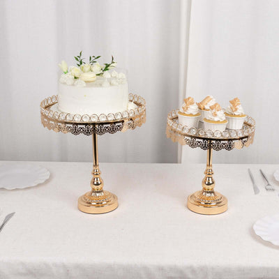 Elegant gold cake stands displaying a cake and cupcakes on a table setting.