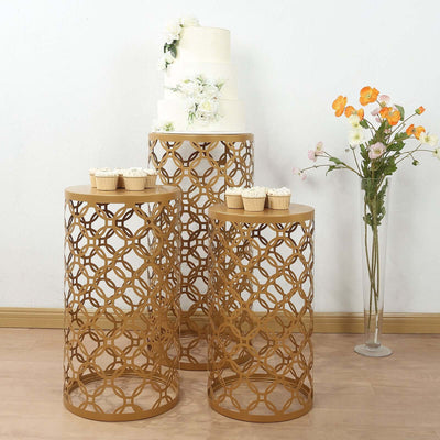 Elegant gold metal side tables with a wedding cake and cupcakes on top.