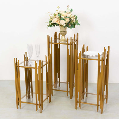 Gold metal accent tables with glass tops and decorative flowers