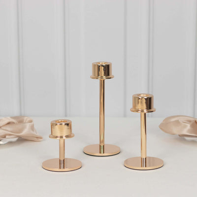 Set of three elegant gold candle holders in varying heights.