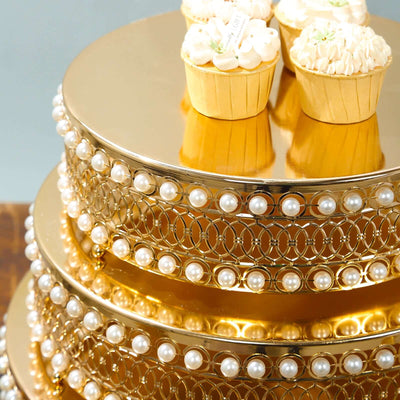 Elegant gold cake stand with cupcakes and pearl accents.