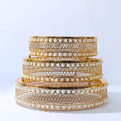 Elegant gold and pearl decorative trays in three stacked tiers
