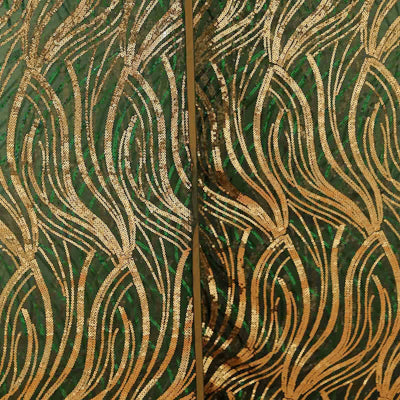 Gold and green textured fabric with wave patterns.