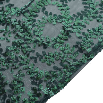 Green sequined lace fabric with intricate leaf patterns.