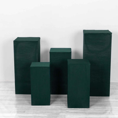 Green display pedestals in various sizes on a white background.