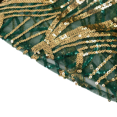 Green and gold sequin fabric with intricate design details.