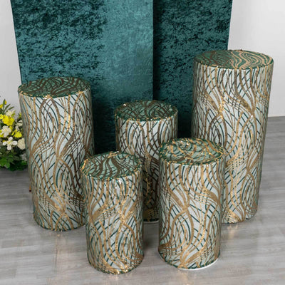 Decorative cylindrical stools with green and gold pattern in various sizes.
