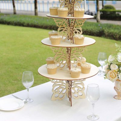 Decorative cupcake stand with cupcakes at an outdoor event.