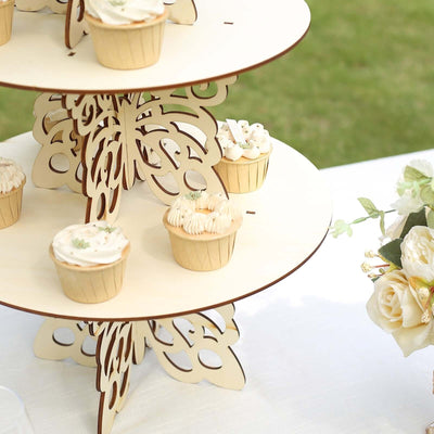 Cupcake stand with decorated cupcakes at an outdoor event.