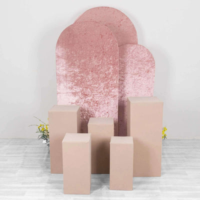 Pink velvet backdrops with beige display pedestals for photography.