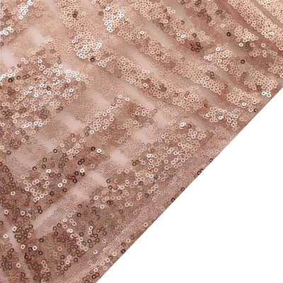 Rose gold sequin fabric with shimmering texture and intricate detail.