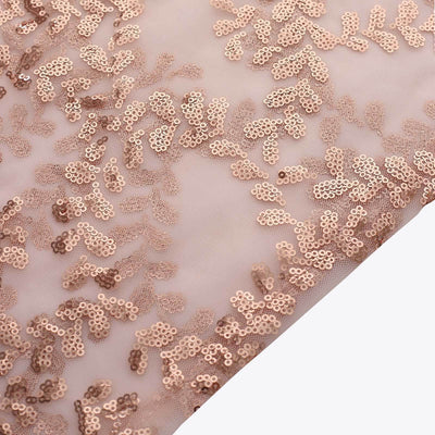 Rose gold sequin fabric with intricate floral patterns.