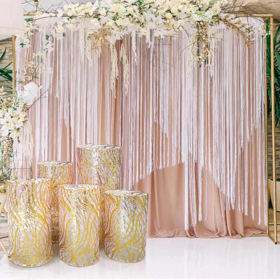 Decorative backdrop with floral accents and elegant gold-patterned pedestals.