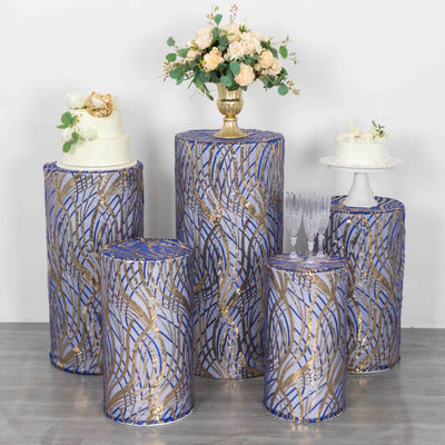 Decorative pedestal stands with floral arrangements and cakes in a staged setting.
