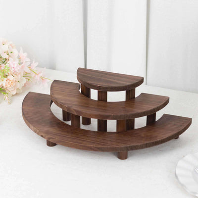 Wooden tiered display stand in elegant curved design.
