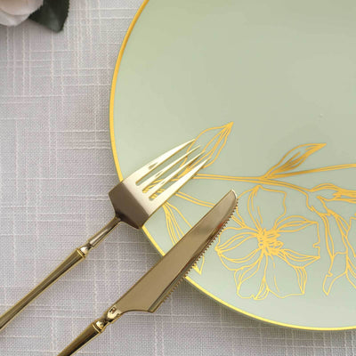 Elegant green plate with gold floral design, fork and knife set.