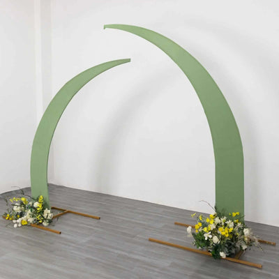 Green arch display with floral arrangements at the base.