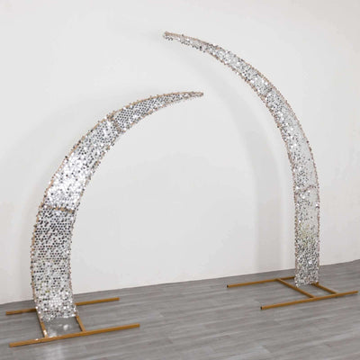 Decorative silver and gold arch sculpture with curved design.