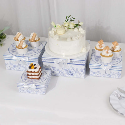 Decorative cake and dessert boxes with floral designs on a table.