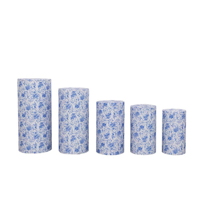 Blue floral decorative cylinder vases in varying heights on a white background.