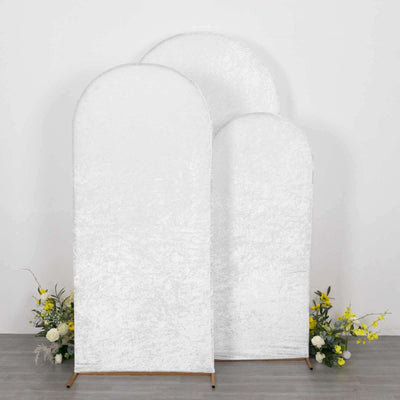 Three textured white backdrops with floral arrangements at the base.