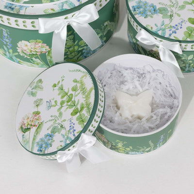 Decorative gift boxes with floral designs and a butterfly-shaped soap inside.