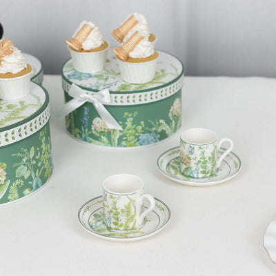 Floral-themed tea set with decorative cupcakes on a display.