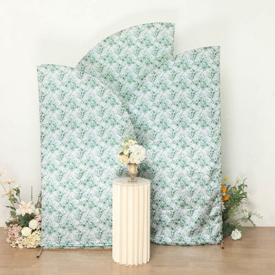 Decorative floral backdrop with a pedestal table and vase of flowers.