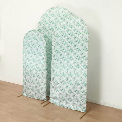Decorative fabric panels in green floral design, standing on a wooden floor.