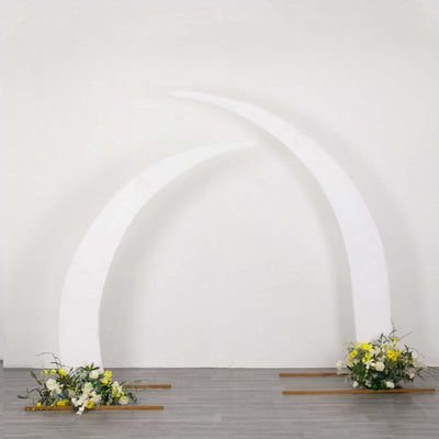 White archway decor with floral arrangements at the base
