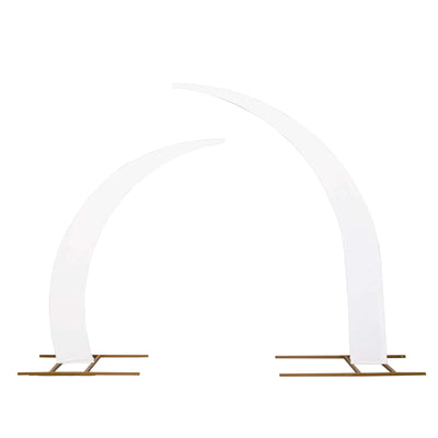 White decorative arches with gold bases on a plain background