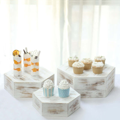 Dessert display on hexagonal stands featuring cupcakes and parfaits.