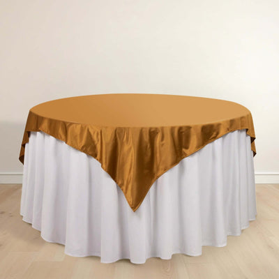 Round table with gold satin tablecloth and white skirt
