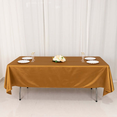 Elegant brown tablecloth set for dining with floral centerpiece and plates.