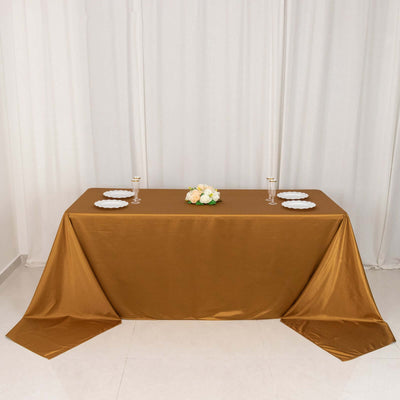 Elegant brown tablecloth draped over a table with decorative flowers and plates.