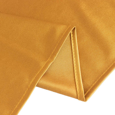 Gold fabric with a smooth texture and folded edge.