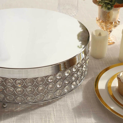 Elegant round cake stand with crystal accents and polished silver finish.