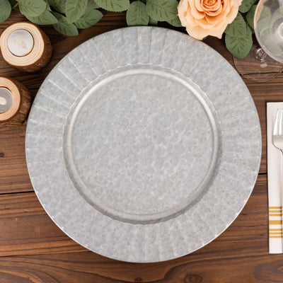 Galvanized metal plate with a textured rim on a wooden table.