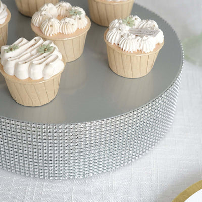 Mini cupcakes with elegant frosting on a decorative silver stand.