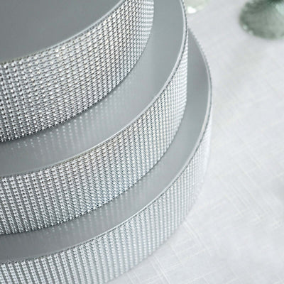 Silver rhinestone ribbon rolls stacked elegantly.
