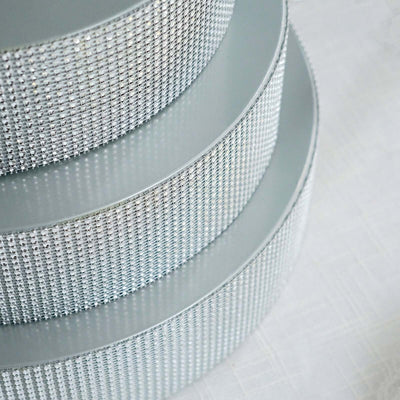 Silver rhinestone ribbon rolls stacked elegantly.