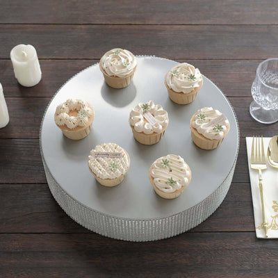 Assorted decorative cupcakes on a silver display stand.