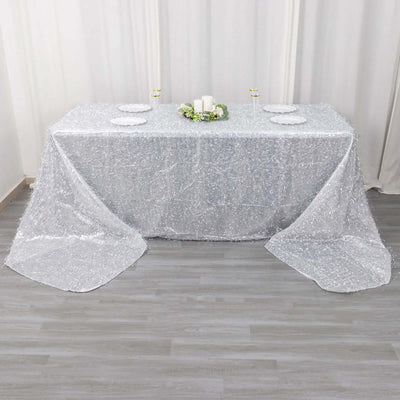 Sparkling silver tablecloth draped over a table for elegant decor.