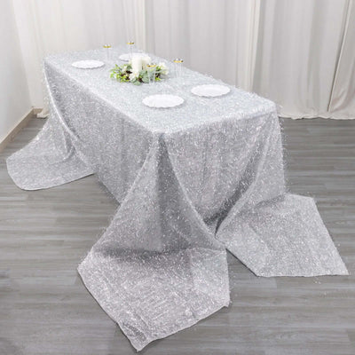 Sparkling silver tablecloth draped elegantly over a table for events or celebrations.