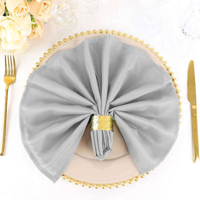 Elegant gray napkin on a decorative plate with golden trim.