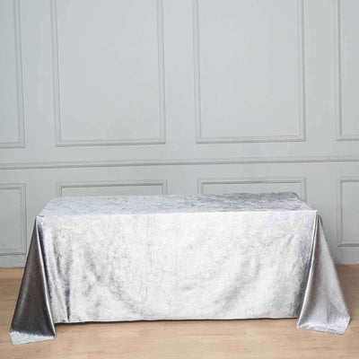 Silver tablecloth draped over a table in a stylish setting.